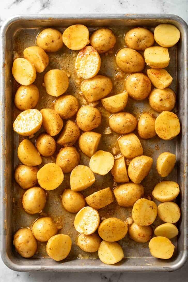 Recipe for Green Beans and Potatoes Baby Yukon Gold Potatoes cut in half on a baking sheet.