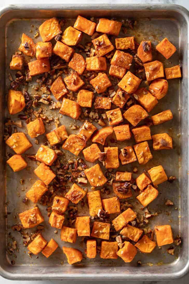 Maple Glazed Sweet Potatoes Maple Glazed Sweet Potatoes on a baking sheet.