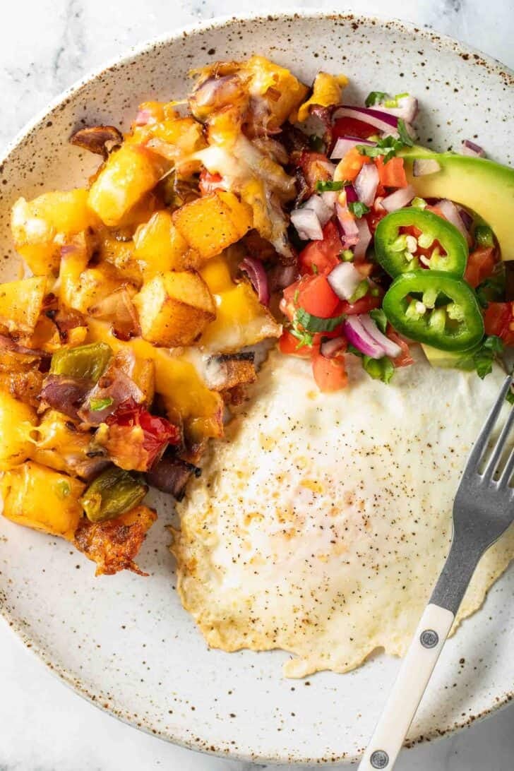 Mexican Breakfast Potatoes Mexican Breakfast Potatoes on a plate with a fried egg.
