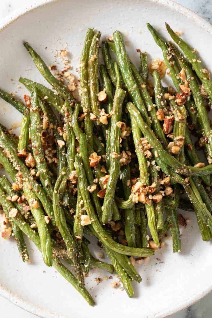 Oven Roasted Green Beans Oven Roasted Green Beans on a white plate.