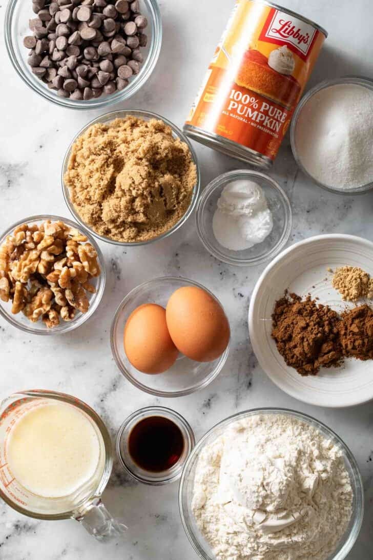 Pumpkin Chocolate Chip Muffins Recipe Ingredients in glass bowls for a recipe for a Pumpkin Chocolate Chip Muffins Recipe.