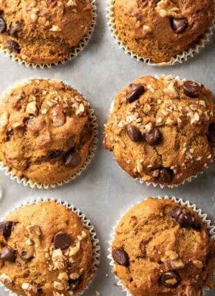Baked Chocolate Chip Pumpkin Muffins in a muffin tin.