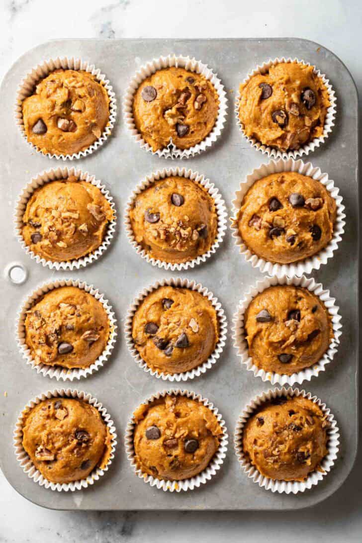 Pumpkin Chocolate Chip Muffins Chocolate Chip Pumpkin Muffins batter scooped into muffin tins.