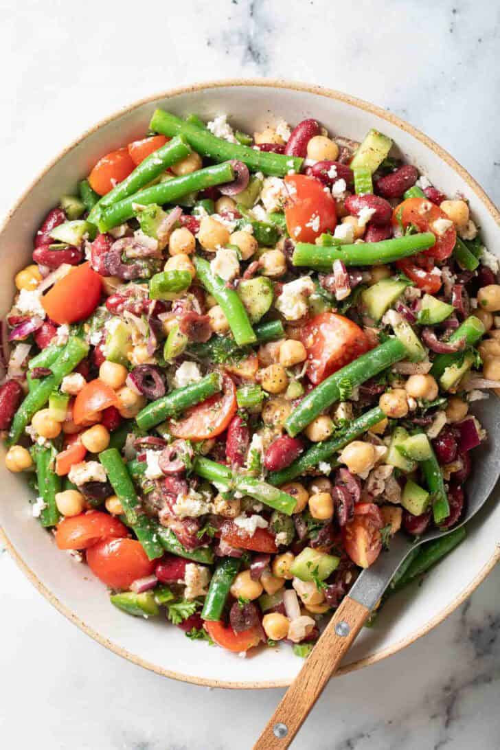 3 Bean Salad Recipe 3 Bean Salad in a white serving bowl with a spoon.