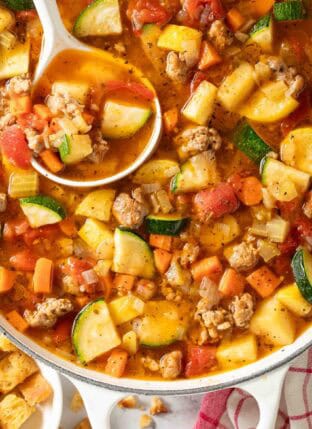 Italian Sausage Vegetable Soup in a white pot.