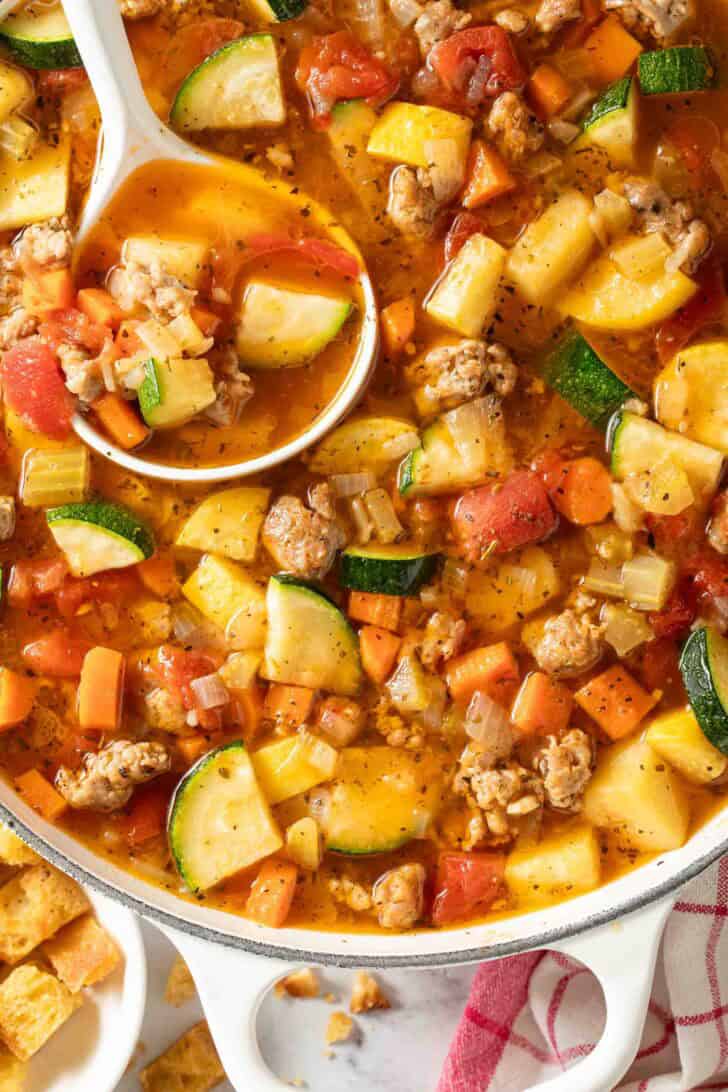 Italian Sausage and Vegetable Soup Italian Sausage and Vegetable Soup in a white Dutch oven.