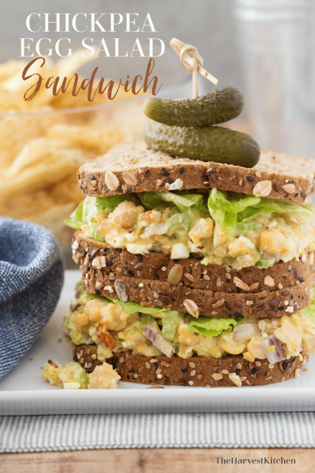 A chickpea and egg sandwich on a white plate.